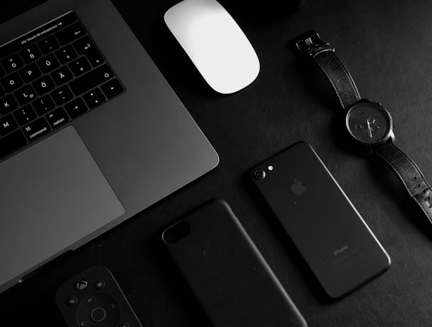 jet black iPhone 7 beside analog watch