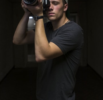 man taking photo using Canon DSLR camera